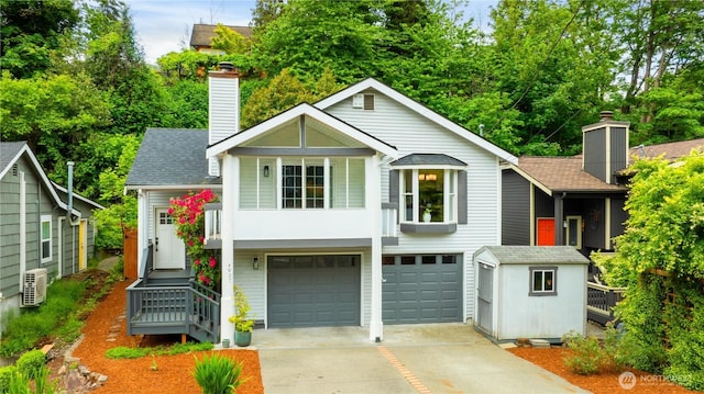 view of front of house with a chimney, concrete driveway, a garage, and roof with shingles