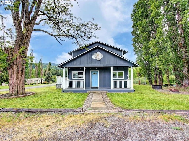 823 D St, Vader, WA 98593 - bungalow with a porch and a front lawn