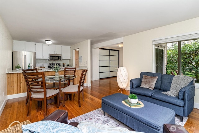 living room with wood finished floors and baseboards