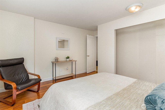 bedroom featuring wood finished floors and baseboards