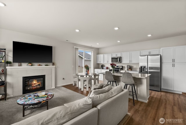 7810 22nd Trl SE, Lacey, WA 98503 - living room featuring dark wood-style floors, recessed lighting, and a tiled fireplace