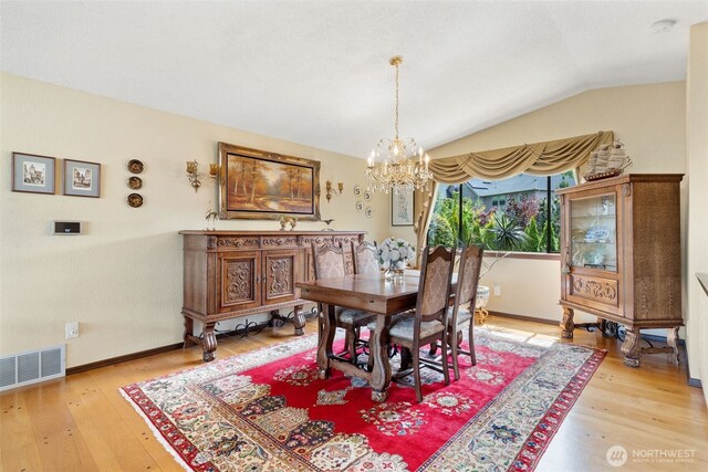 916 Kari Ln, Steilacoom, WA 98388 - dining area featuring a chandelier, light wood finished floors, vaulted ceiling, and baseboards