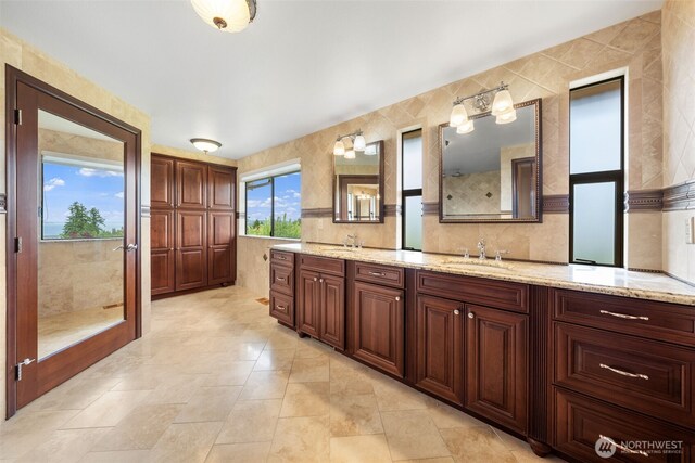916 Kari Ln, Steilacoom, WA 98388 - bathroom featuring double vanity and tile walls