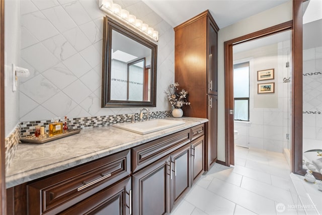 916 Kari Ln, Steilacoom, WA 98388 - bathroom featuring vanity, toilet, tile walls, and tasteful backsplash