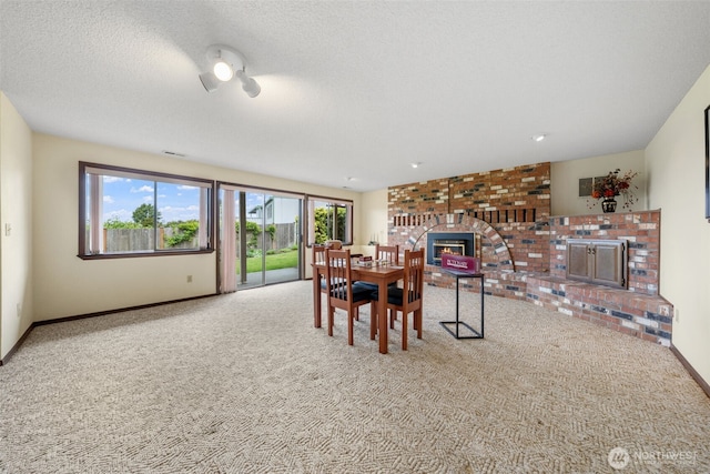 916 Kari Ln, Steilacoom, WA 98388 - dining room featuring a brick fireplace, carpet, and baseboards