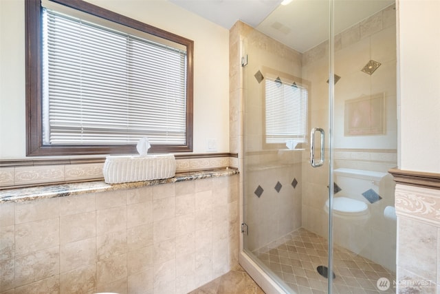 916 Kari Ln, Steilacoom, WA 98388 - full bath with tile walls, a stall shower, tile patterned floors, and a wainscoted wall