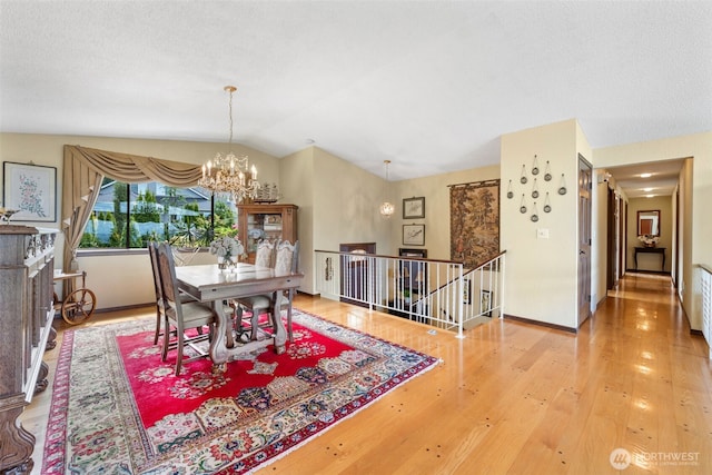 916 Kari Ln, Steilacoom, WA 98388 - dining room with lofted ceiling, a chandelier, wood finished floors, and baseboards