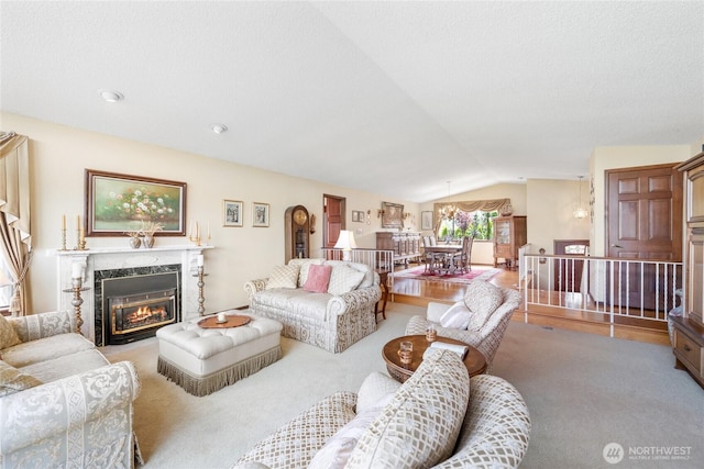 916 Kari Ln, Steilacoom, WA 98388 - living area featuring lofted ceiling, carpet, and a premium fireplace