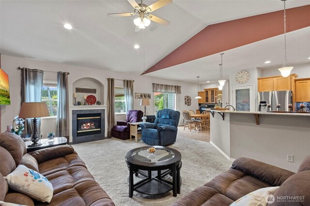 2557 Captains Ct, Ferndale, WA 98248 - living room with a ceiling fan, lofted ceiling, light carpet, recessed lighting, and a tiled fireplace