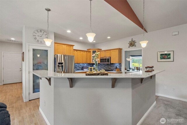 2557 Captains Ct, Ferndale, WA 98248 - kitchen featuring stainless steel appliances, a kitchen breakfast bar, baseboards, recessed lighting, and decorative backsplash