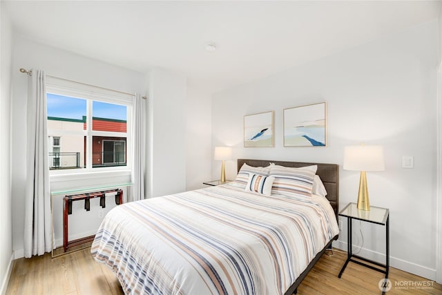 2331 42nd Ave SW Unit 403, Seattle, WA 98116 - bedroom with wood finished floors and baseboards
