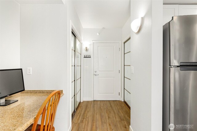 2331 42nd Ave SW Unit 403, Seattle, WA 98116 - hallway featuring light wood finished floors and baseboards