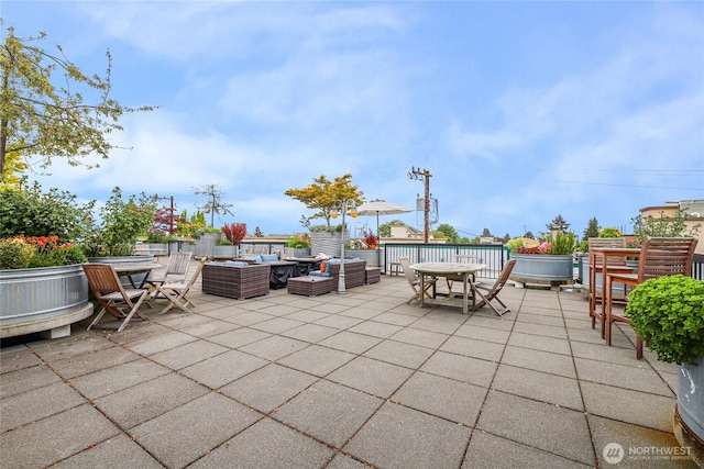 2331 42nd Ave SW Unit 403, Seattle, WA 98116 - view of patio featuring an outdoor hangout area and outdoor dining space