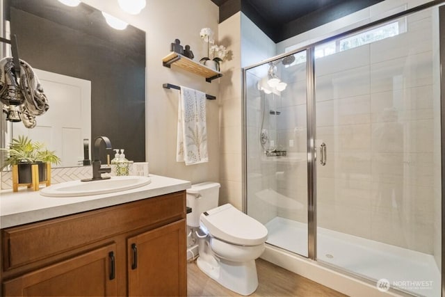 4471 Hales Ct SW, Port Orchard, WA 98367 - bathroom featuring toilet, a shower stall, vanity, decorative backsplash, and wood finished floors