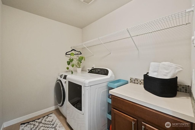 4471 Hales Ct SW, Port Orchard, WA 98367 - laundry area featuring washing machine and clothes dryer, baseboards, and cabinet space
