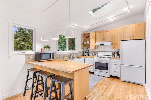 2920 Cedar Ave, Lummi Island, WA 98262 - kitchen featuring white appliances, under cabinet range hood, track lighting, butcher block counters, and backsplash