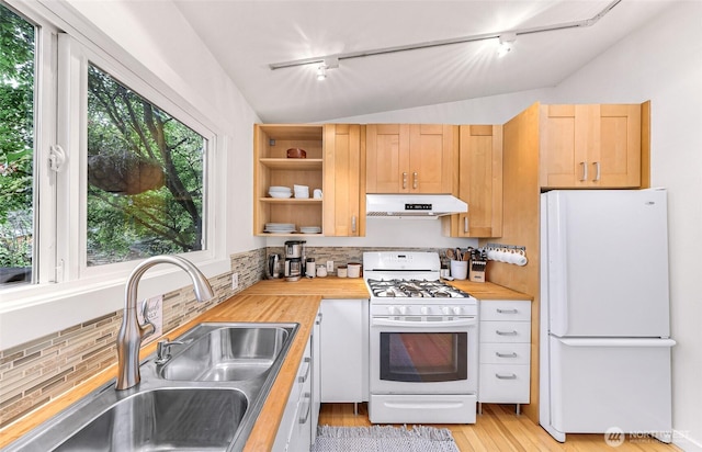 2920 Cedar Ave, Lummi Island, WA 98262 - kitchen with white appliances, under cabinet range hood, rail lighting, butcher block counters, and lofted ceiling