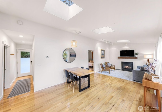 2920 Cedar Ave, Lummi Island, WA 98262 - living room with a skylight, a glass covered fireplace, light wood-type flooring, and track lighting