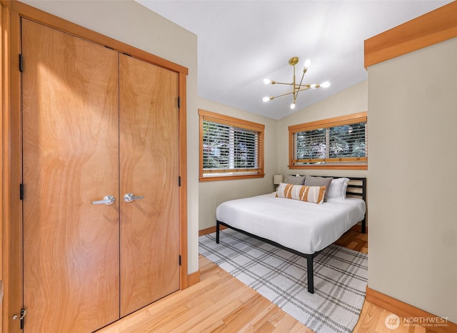 2920 Cedar Ave, Lummi Island, WA 98262 - bedroom with a chandelier, light wood finished floors, vaulted ceiling, and a closet