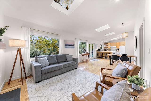 2920 Cedar Ave, Lummi Island, WA 98262 - living area featuring a skylight, light wood-style floors, and lofted ceiling