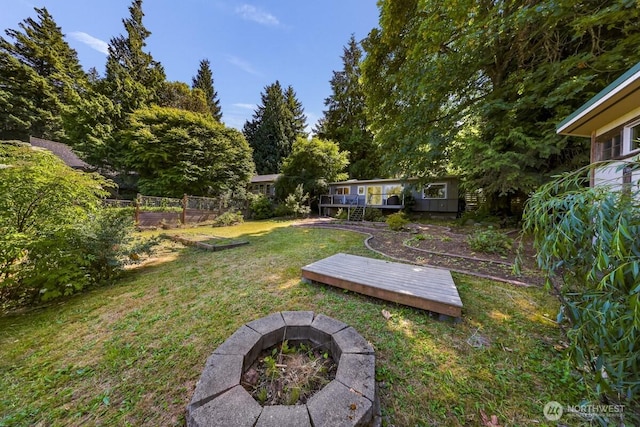 2920 Cedar Ave, Lummi Island, WA 98262 - view of green lawn with an outdoor fire pit, a garden, and a deck