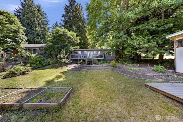 2920 Cedar Ave, Lummi Island, WA 98262 - view of green lawn featuring a vegetable garden and a wooden deck
