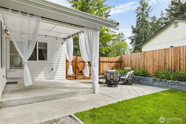 view of patio featuring fence
