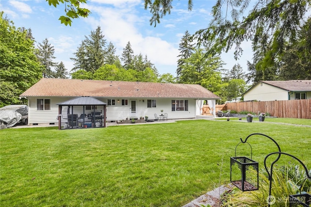 rear view of house with a gazebo, crawl space, and a patio area