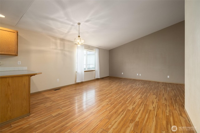 463 Rohrer Loop, Sedro Woolley, WA 98284 - unfurnished living room featuring light wood finished floors, a chandelier, and lofted ceiling