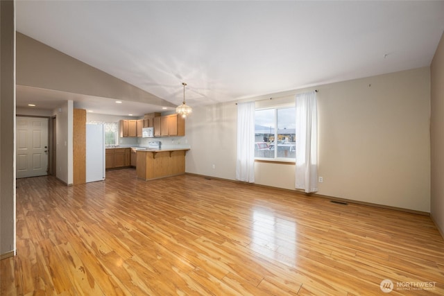 463 Rohrer Loop, Sedro Woolley, WA 98284 - unfurnished living room with light wood finished floors and vaulted ceiling