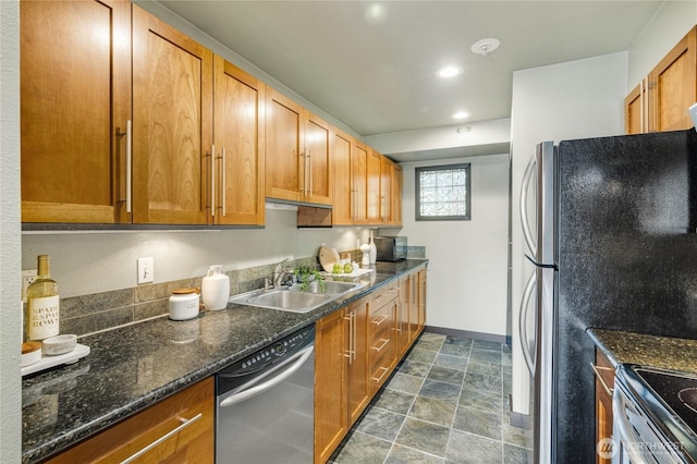 1504 Aurora Ave N Unit 407, Seattle, WA 98109 - kitchen featuring appliances with stainless steel finishes, brown cabinets, stone finish flooring, recessed lighting, and dark stone counters