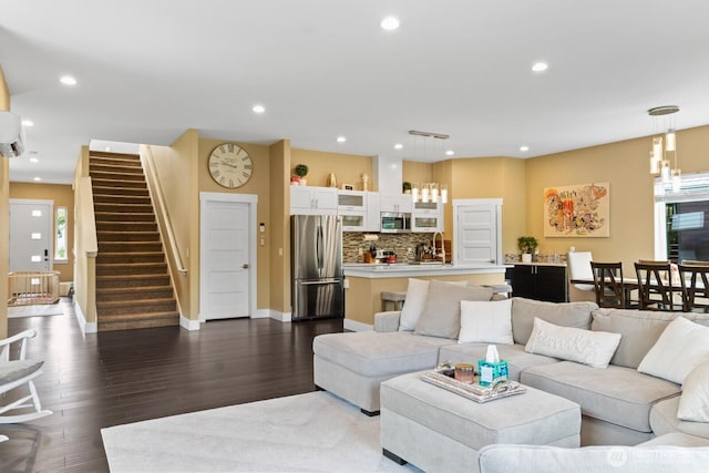 2311 S 135th Ln, Seattle, WA 98168 - living room with dark wood-style flooring, stairs, baseboards, recessed lighting, and a wall mounted air conditioner