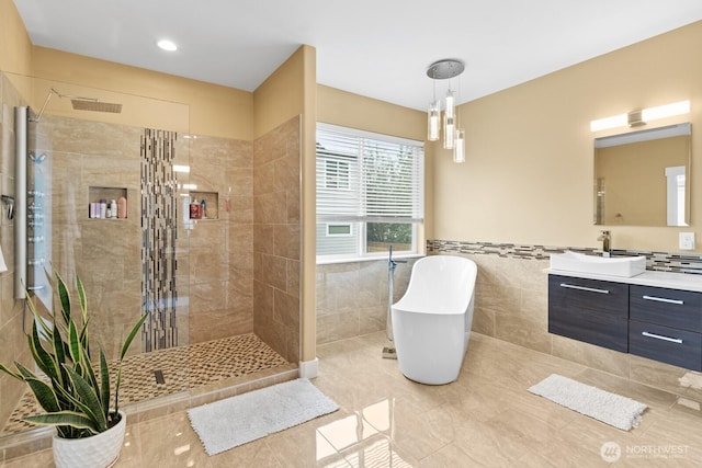 2311 S 135th Ln, Seattle, WA 98168 - full bathroom featuring a tile shower, a freestanding bath, vanity, tile walls, and tile patterned flooring
