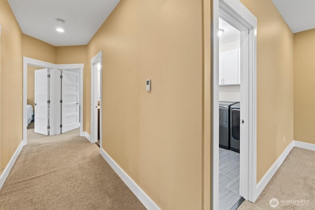 2311 S 135th Ln, Seattle, WA 98168 - corridor with light colored carpet, washer and clothes dryer, and baseboards