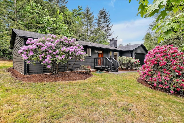single story home featuring a chimney and a front lawn