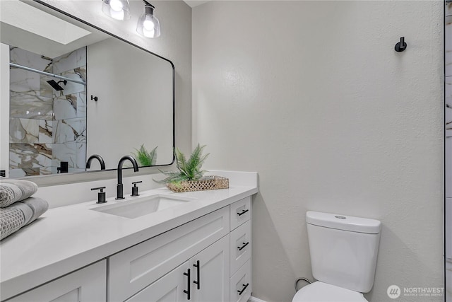 bathroom with a marble finish shower, toilet, and vanity