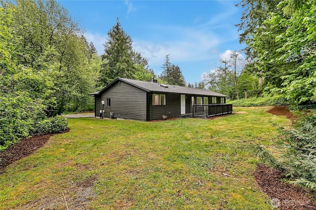 back of property featuring a lawn and a chimney
