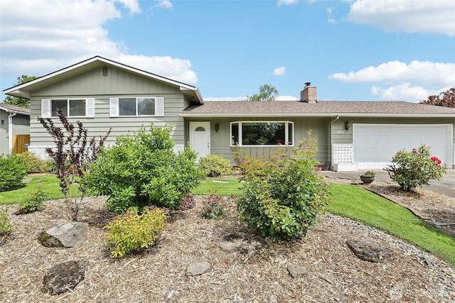 view of front of home featuring a chimney, an attached garage, concrete driveway, and roof with shingles