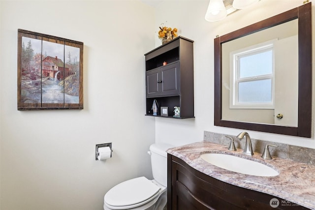 bathroom with toilet and vanity