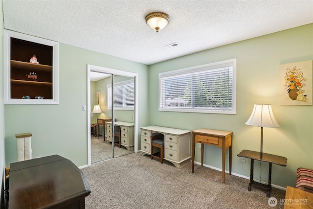 office space featuring carpet flooring, a textured ceiling, and baseboards