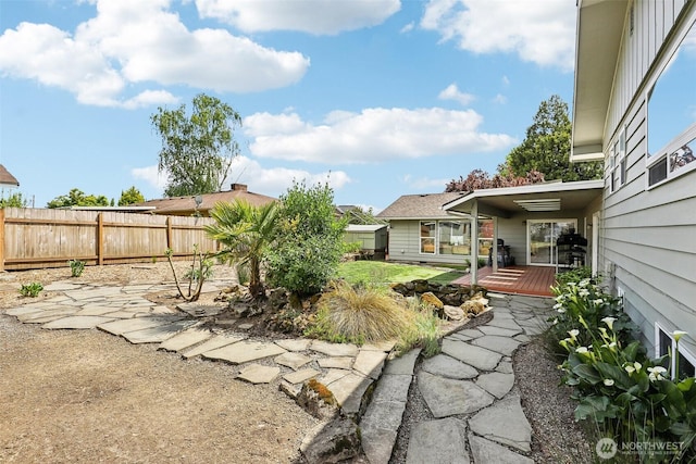 view of yard with fence and a wooden deck