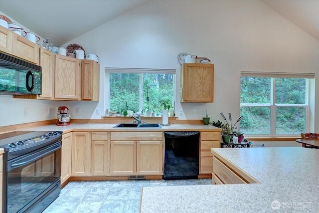 9535 Olalla Valley Rd SE, Port Orchard, WA 98367 - kitchen with black appliances, light brown cabinetry, high vaulted ceiling, a sink, and light countertops