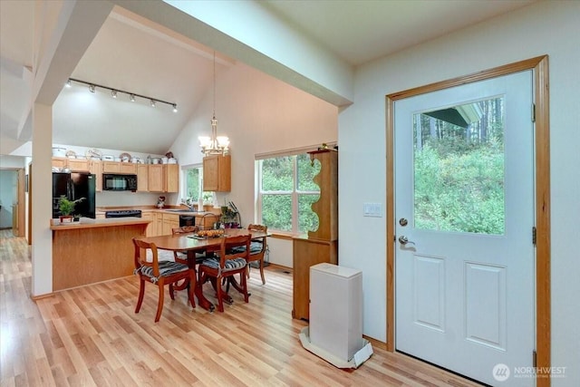 9535 Olalla Valley Rd SE, Port Orchard, WA 98367 - dining space featuring track lighting, light wood-style flooring, vaulted ceiling, and a chandelier