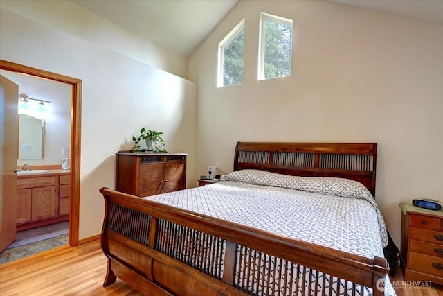 9535 Olalla Valley Rd SE, Port Orchard, WA 98367 - bedroom with a sink, light wood-style floors, connected bathroom, and lofted ceiling