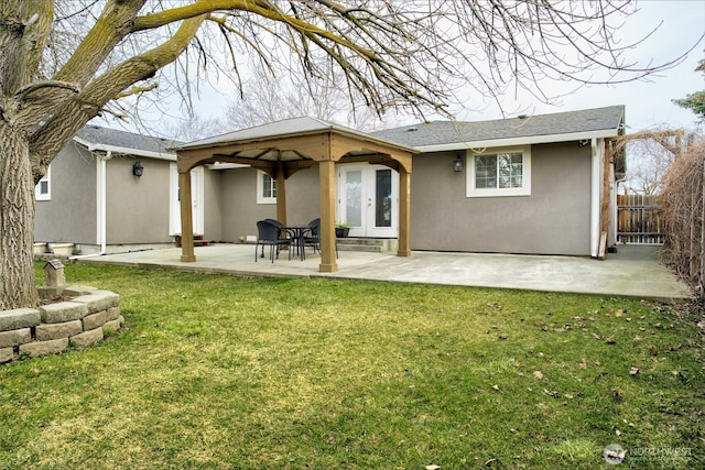 515 N Shelley Ave, Othello, WA 99344 - rear view of house with stucco siding, a patio, and french doors