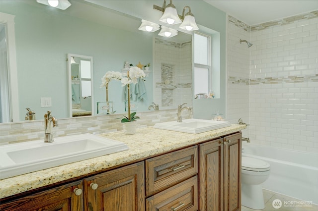 515 N Shelley Ave, Othello, WA 99344 - bathroom featuring toilet, shower / bath combination, double vanity, backsplash, and tile patterned floors