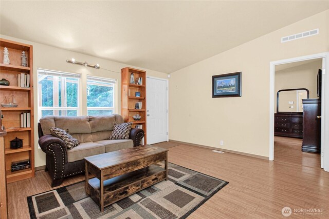 178 Bear View Dr, Chehalis, WA 98532 - living area featuring vaulted ceiling, wood finished floors, and baseboards