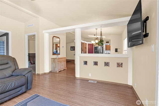 178 Bear View Dr, Chehalis, WA 98532 - living room featuring baseboards, wood finished floors, a chandelier, and vaulted ceiling