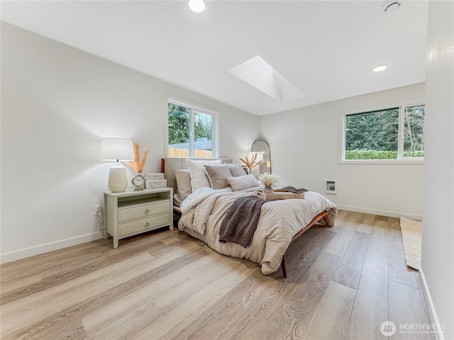 22406 121st Dr NE, Arlington, WA 98223 - bedroom with a skylight, wood finished floors, baseboards, and recessed lighting