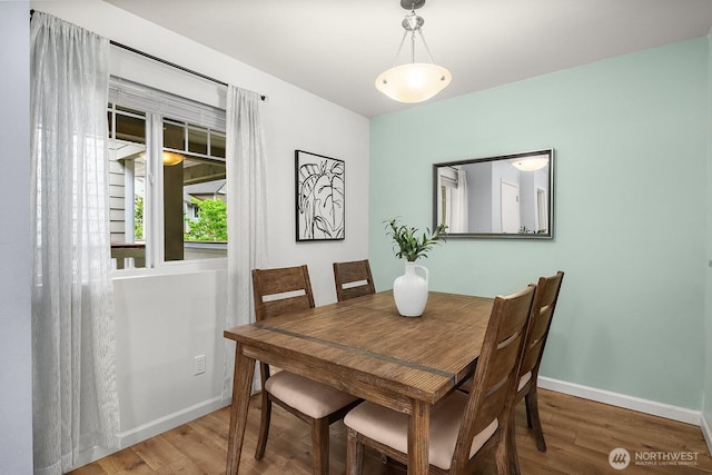 dining room with wood finished floors and baseboards